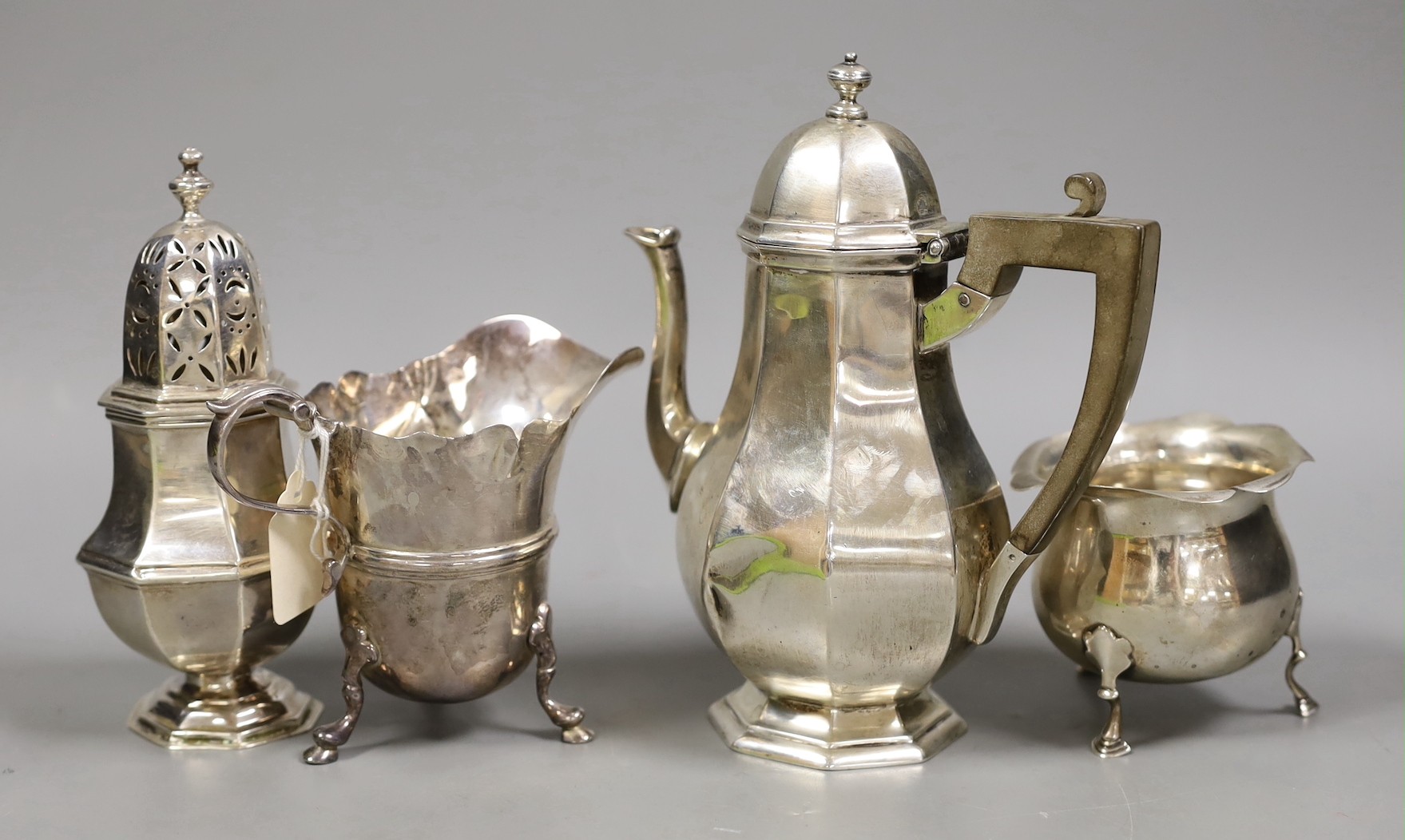 A George V silver octagonal hot water pot, a.f. and six other items of small silver including pair of salts, caster, cream jug, bowl and sauce ladle, 23.4oz.